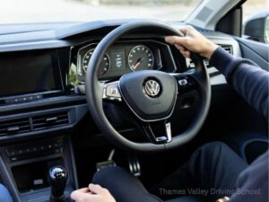 interior view of a pupil learning to drive in a VW polo from thames valley driving school in Wallingford, Oxon, UK. manual transmission car.